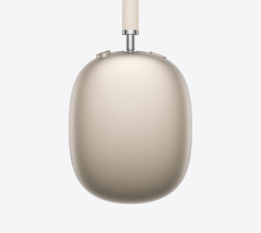 Imagem da lateral dos fones de ouvido AirPods Max 2 na cor estelar mostrando detalhes da haste ajustável, almofada, Digital Crown e botão de controle de ruído